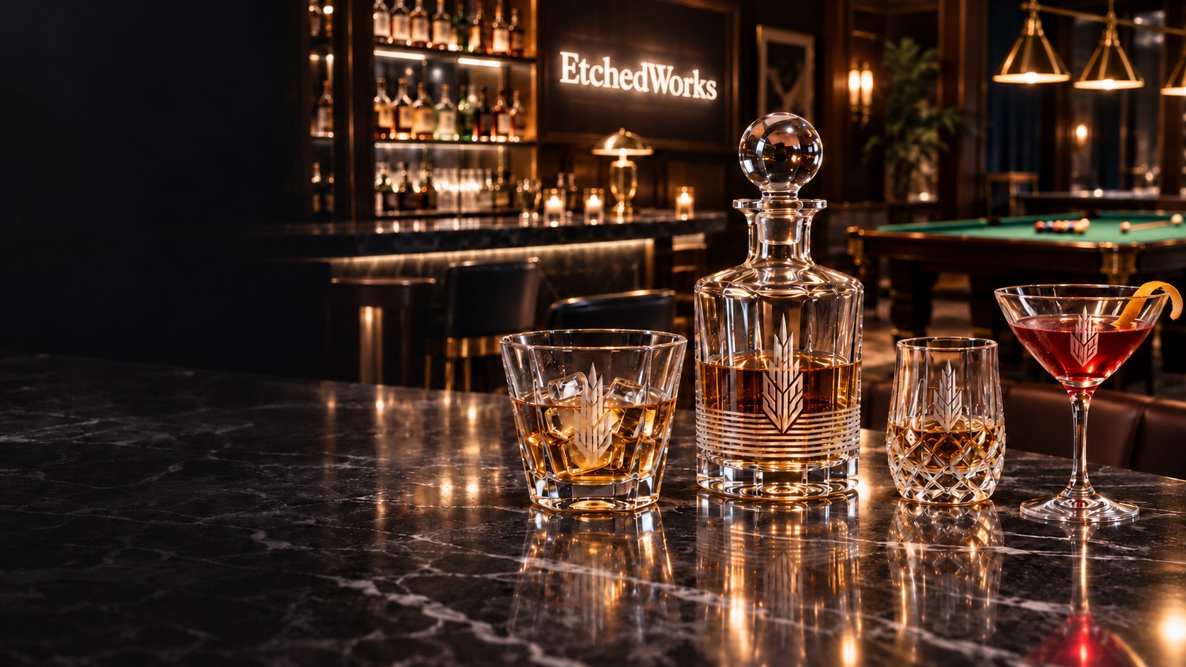 Deep etched barware on a marble counter in a high-end bar with an EtchedWorks sign and pool table